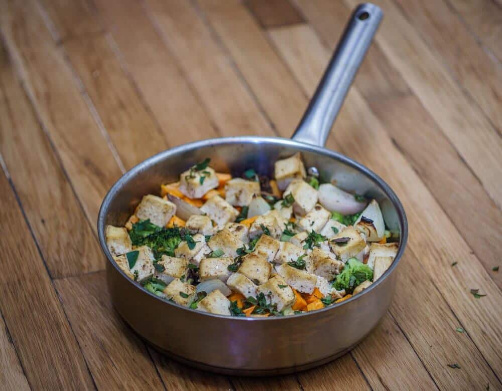 Tofu under a brick in a pot on the table