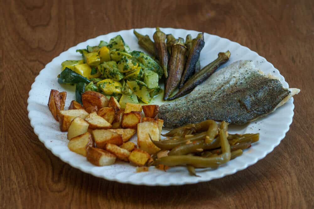 Meal of trout, okra, green beans, potatoes and squash