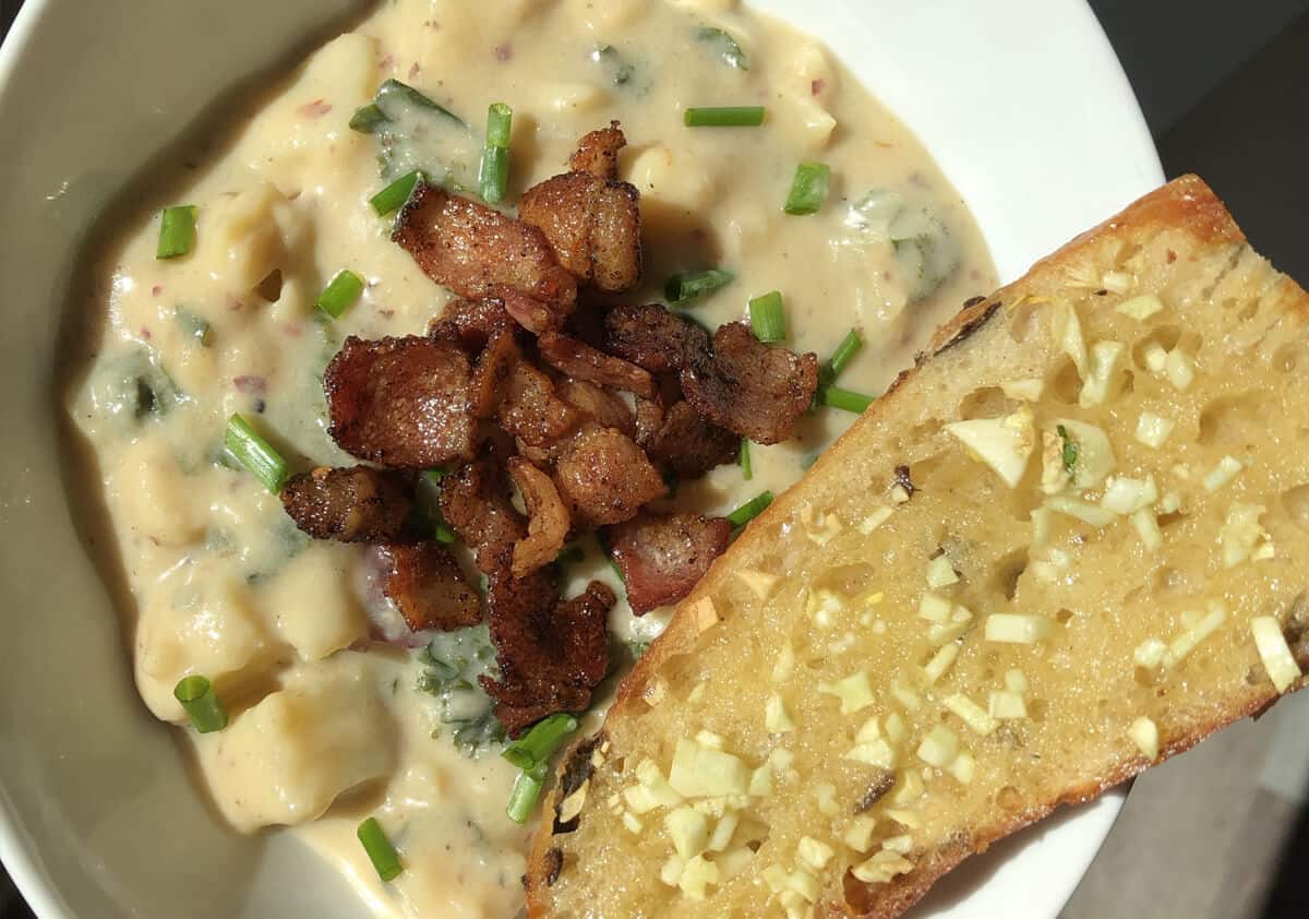 Baked potato soup with bacon and a baguette