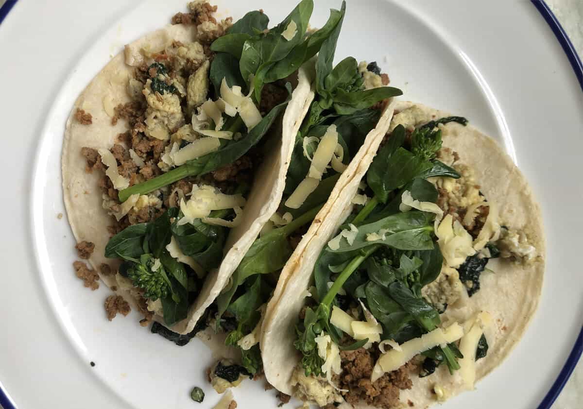 Breakfast tacos on a white plate