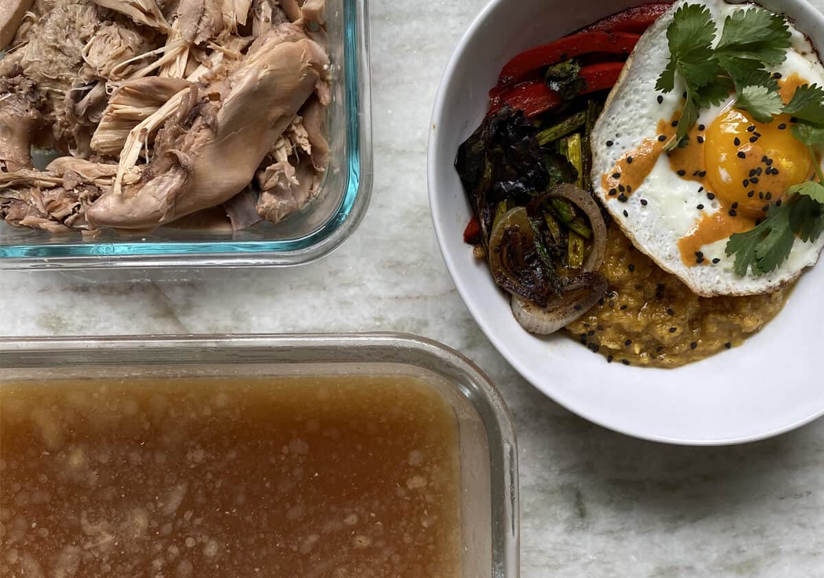Roasted chicken, broth, and eggs in dishes on a table