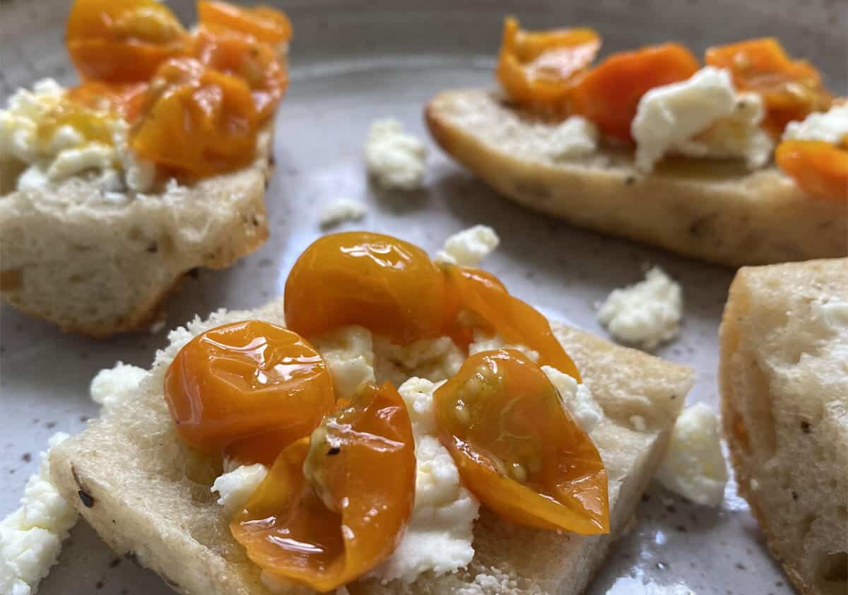Mushroom baguette with goat cheese and sungold tomatoes on a plate