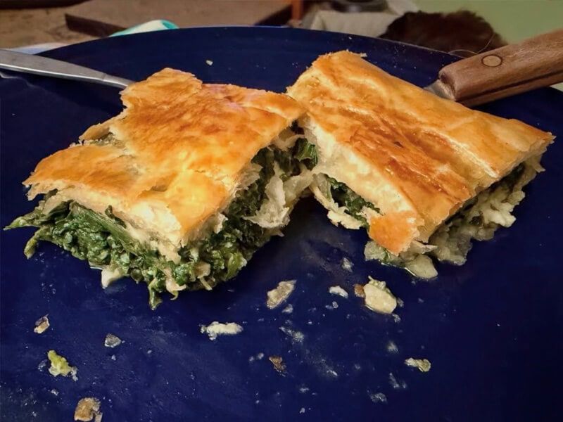 main-st-farmers-market-hissing-possum-norwegian-spinach-pie Norwegian Spinach Pie from Hissing Possum Farms on a blue plate